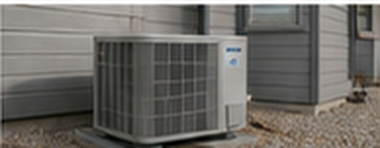 An air conditioning condenser beside a house