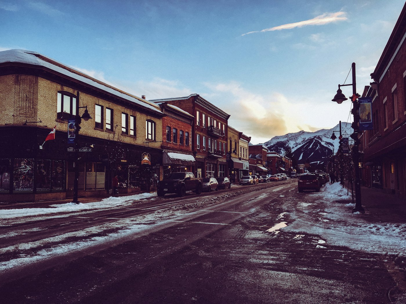 Victoria Avenue in downtown Fernie on a winter evening, with the Lizard Range behind